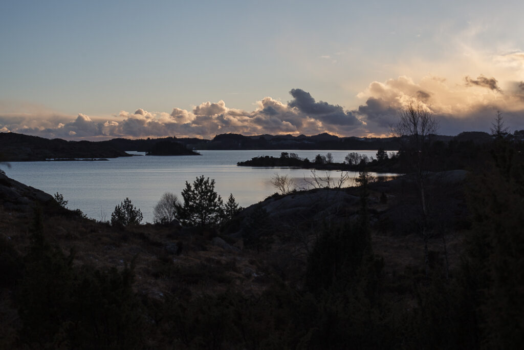 Sunset with clouds and a bit of water in the forground